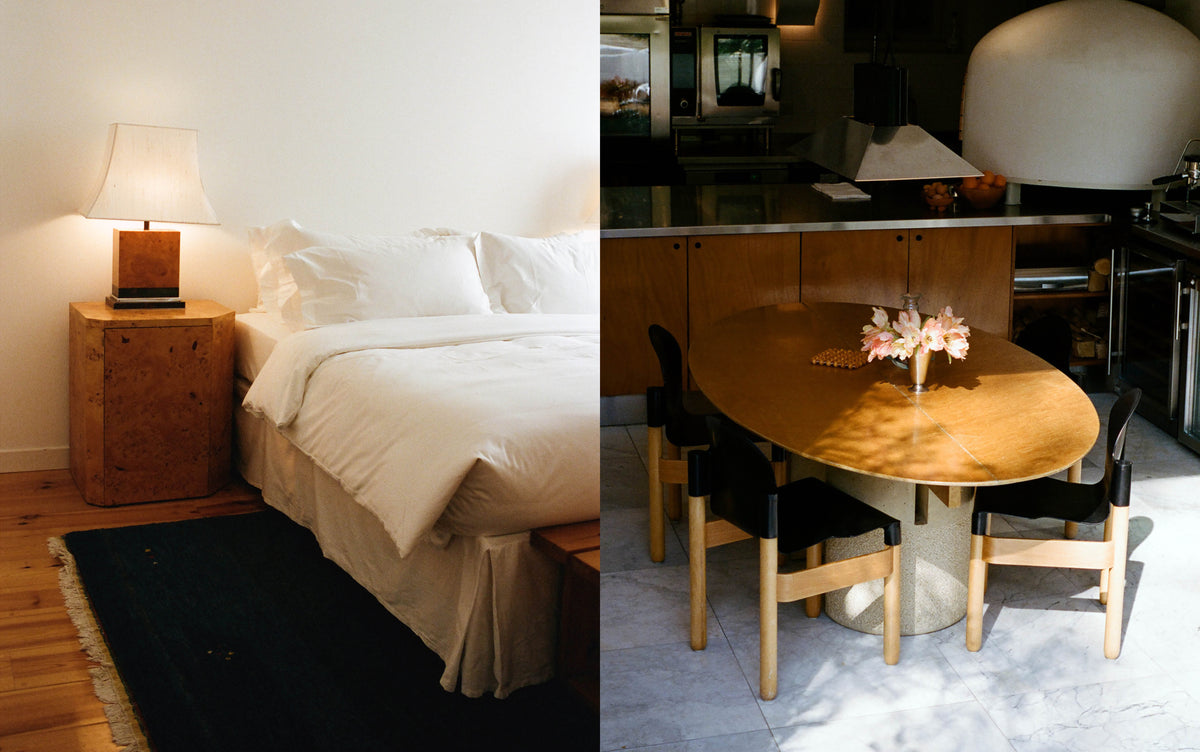 A guest room with a burl-wood bedside table, and the oval dining table in the CARMEN kitchen